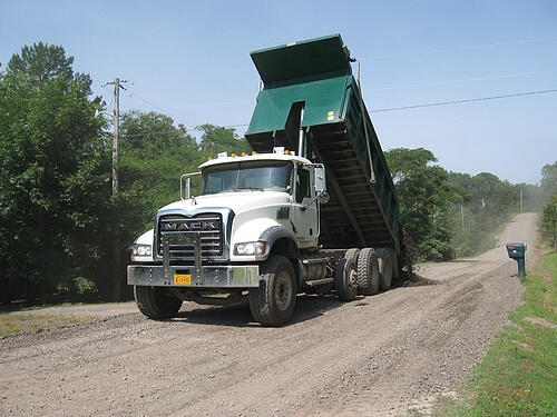Pope County Road Department truck dumping gravel